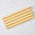 Set of five 12-inch amber unscented taper candles with gold HG logo embossing and cotton wicks.