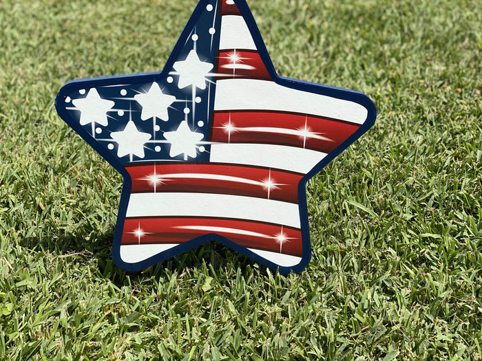 American Flag Yard Sign in the shape of a star featuring red and white stripes and blue and white start. Deocarative lawn signs for yards, porches, patios, gardens, driveways and walkways available for sale at Yard Art Decor and More. Made in the USA.  Ships from the USA. Free Shipping included.