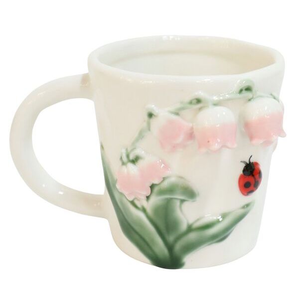 Ceramic mug with a ladybug and floral design