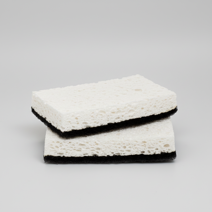 Set of 2 rectangular black and white kitchen scourer sponges with textured white top and black base.