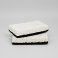 Set of 2 rectangular black and white kitchen scourer sponges with textured white top and black base.