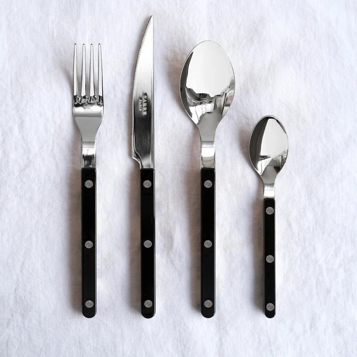 Black Bistro 5-piece flatware set: stainless steel with black acrylic handles, includes fork, knife, and two spoons.