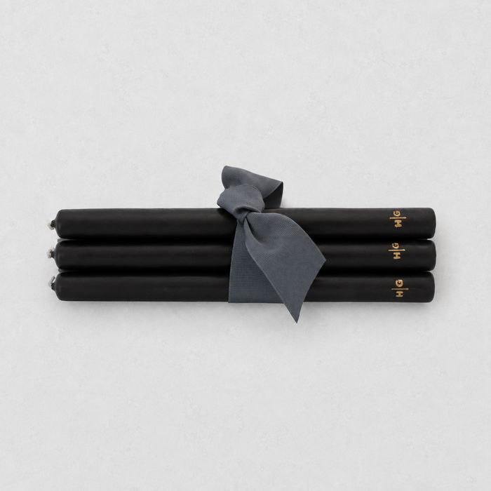 Set of five 10-inch black unscented taper candles tied with a grey ribbon, featuring a gold embossed Hudson Grace logo.
