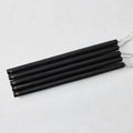 Set of five 17-inch hand-dipped black unscented taper candles with gold HG logo detail on a white background.