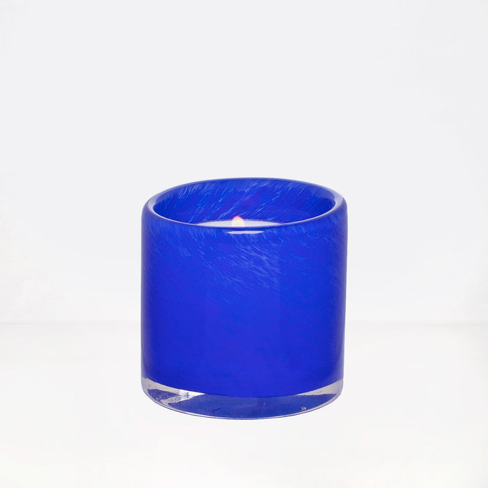 Blue votive glass candle holder, mouth-blown, hand-formed, 2.75"Dia x 2.75"H, with lit candle.