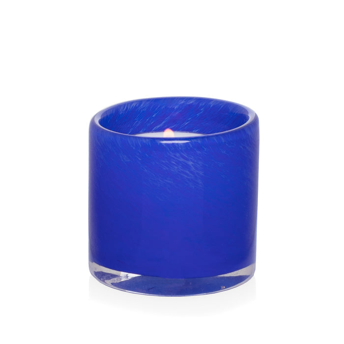 Blue votive glass candle holder, mouth-blown, hand-formed, 2.75"Dia x 2.75"H, with lit candle.