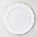White round ceramic serving platter with a raised trimmed edge.