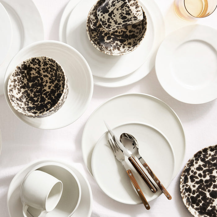Buffalo Bistro 5-piece stainless steel flatware set with brown acrylic handles arranged on white ceramic plates.
