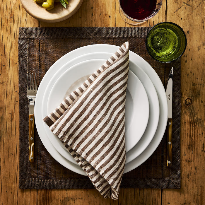 Buffalo Bistro 5-piece flatware set with stainless steel heads and brown acrylic handles on a rustic wooden table.
