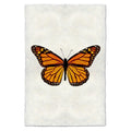 Monarch butterfly print on textured handmade paper, orange and black wings, white background.