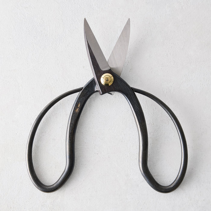 Carbon steel Higurashi garden scissors with dark, uniquely curved handles and a brass pivot.