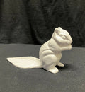 A small white squirrel door stop
