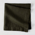 Cedar HG Signature Hand-Dyed Linen Napkin, dark mossy green, folded square, 22-inch.