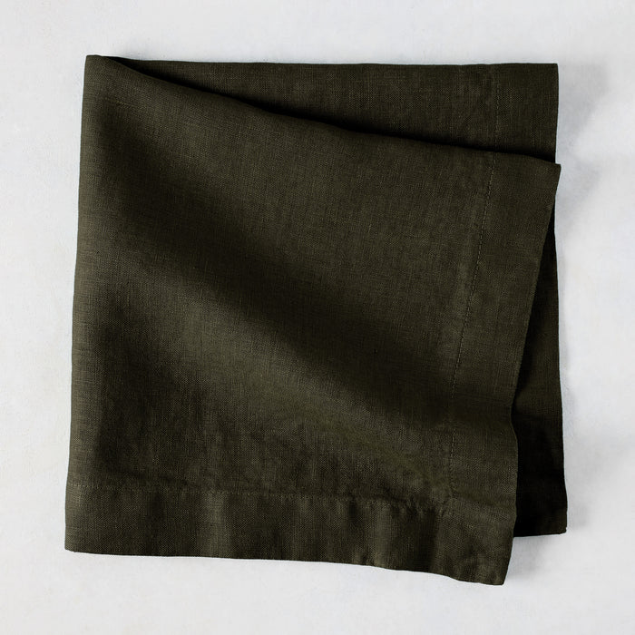 Cedar HG Signature Hand-Dyed Linen Napkin, dark mossy green, folded square, 22-inch.