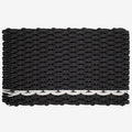 Handwoven charcoal rope doormat with a white pearl stripe along the bottom edge.