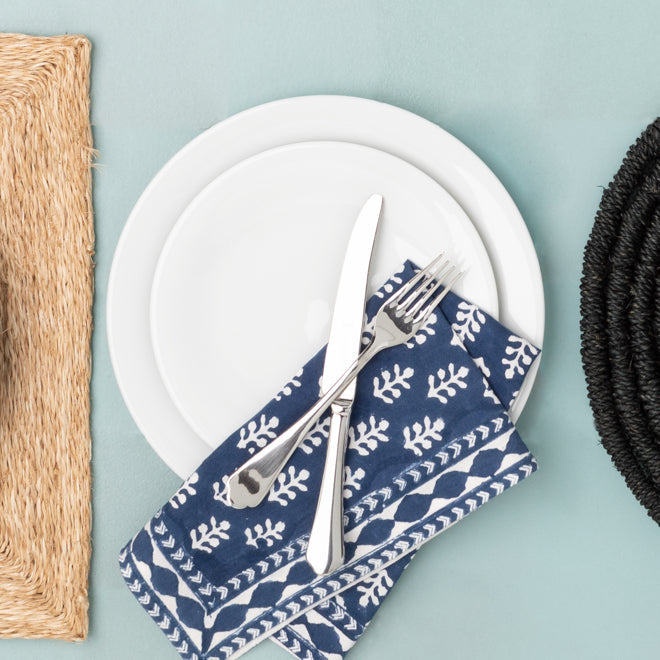 HG City White Porcelain Salad Plate with a blue patterned napkin and silverware.
