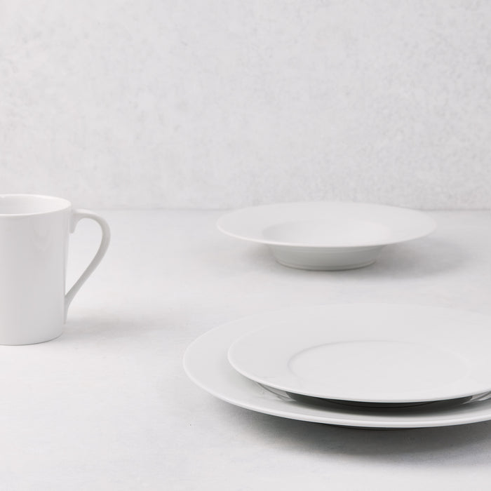White HG Classic Porcelain Dinner Plate, stacked with a smaller plate, bowl, and mug.