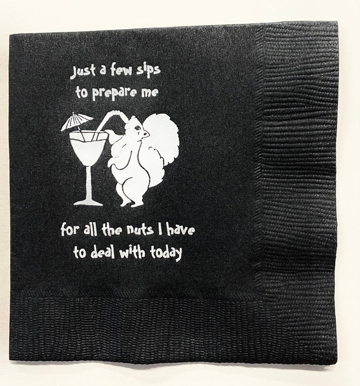 Black cocktail napkin with a white squirrel sipping a martini and saying, "Just a few sips to prepare me for all the nuts I have to deal with today.