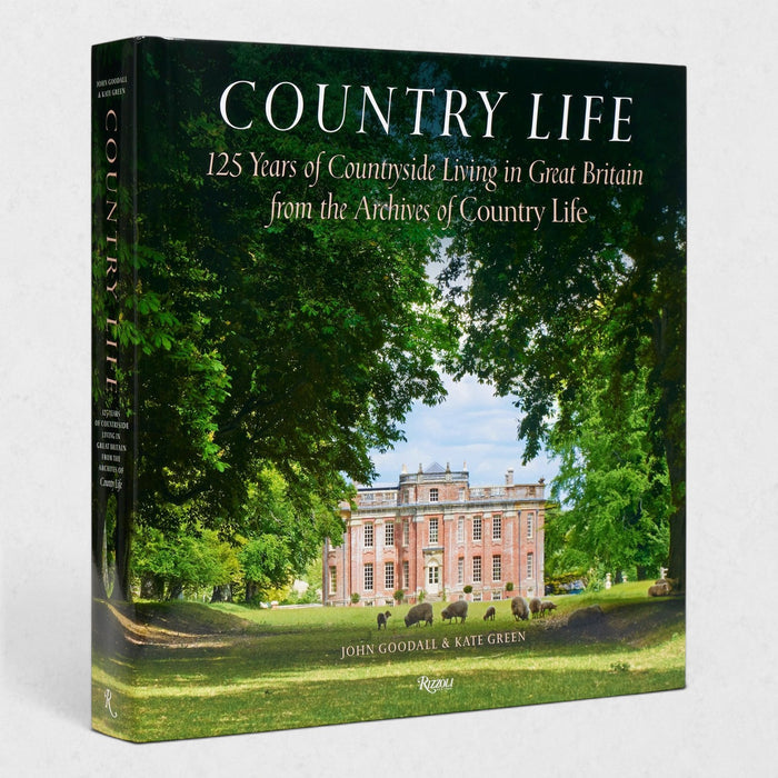 Hardcover coffee table book titled Country Life featuring a British estate and sheep on a green lawn.