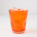 Dark orange Henri mouth-blown glass, 8 oz, filled with ice.