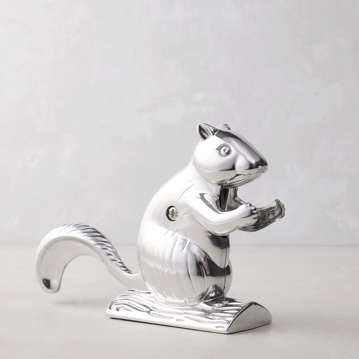 Shiny silver metal squirrel nutcracker, "Davy Crackit" design, holding a nut, on a light background.