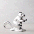 Shiny silver metal squirrel nutcracker, "Davy Crackit" design, holding a nut, on a light background.