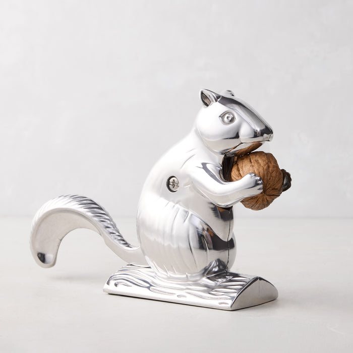 Silver metal squirrel nutcracker, "Davy Crackit," holding a walnut.