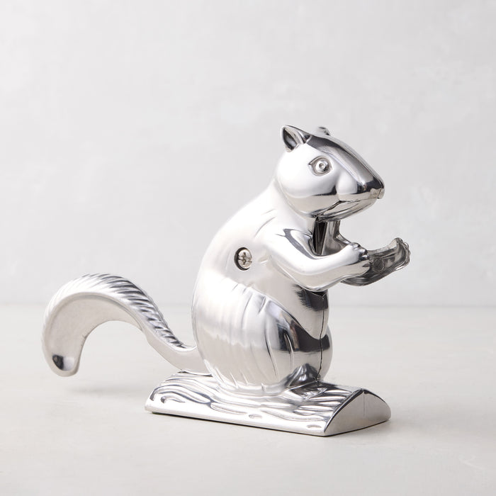 Shiny silver metal squirrel nutcracker, "Davy Crackit" design, on a light gray surface.
