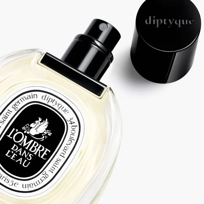 Diptyque perfume bottle with black cap on a white background