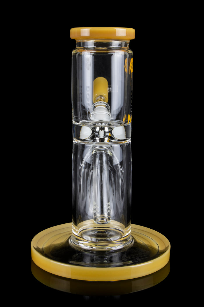 Clear glass water pipe (rig) with a golden base and mouthpiece cap, studio shot on a black background.