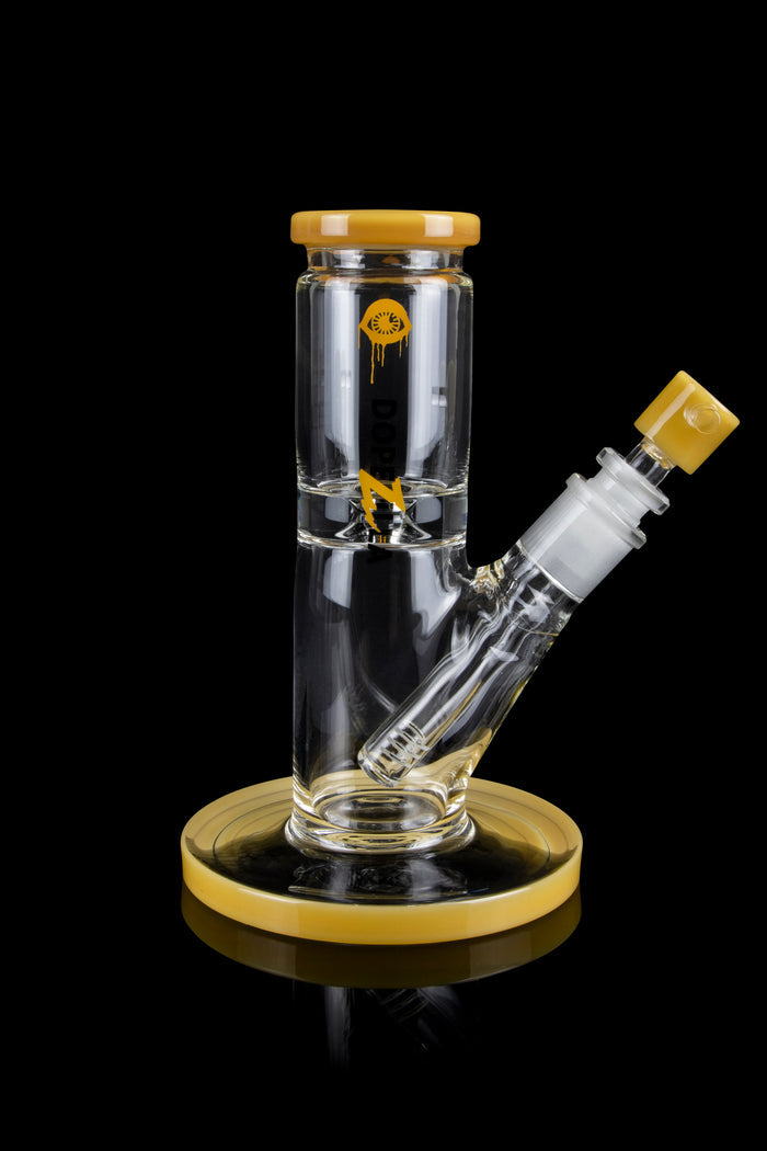 Clear glass water pipe (bong) with gold accents and a cannabis-themed decal, isolated on a black background.