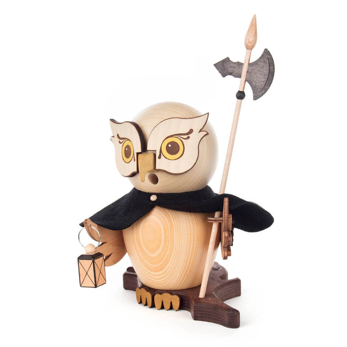 This Dregeno Smoker - Owl Night Watchman is crafted from natural wood and hand-carved in Germany. It features a traditional cloak and holds a lantern and halberd with each wing while standing on a wooden base.