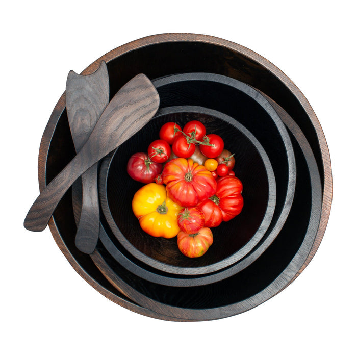 Ebonized rustic spalted maple wood salad servers and nesting bowls with colorful heirloom tomatoes.
