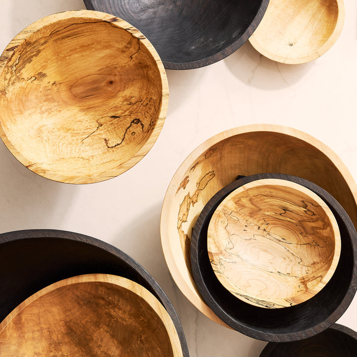 Ebonized and natural spalted wood bowls, various sizes, showcasing unique grain patterns.