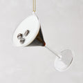 Glass Espresso Martini Christmas ornament, 4"H, with dark liquid, white foam, and three coffee beans.
