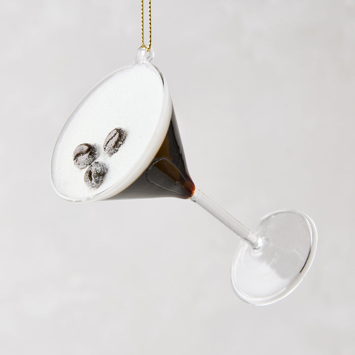 Glass Espresso Martini Christmas ornament, 4"H, with dark liquid, white foam, and three coffee beans.