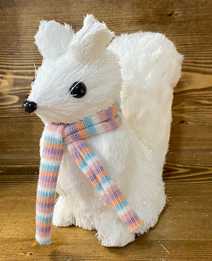 A sisal white squirrel figurine with a pastel striped scarf.