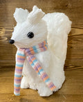 A sisal white squirrel figurine with a pastel striped scarf.