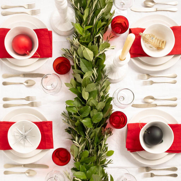 Flame HG Signature hand-dyed linen napkins, 22" square, in vibrant red, styled on a holiday table.