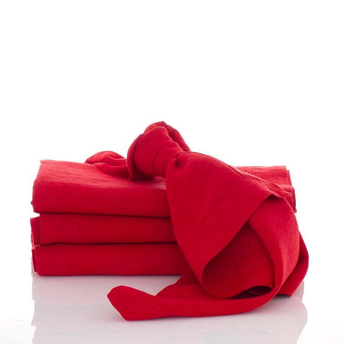 Flame HG Signature hand-dyed red linen napkins, 22-inch square, stacked with one tied in a knot.