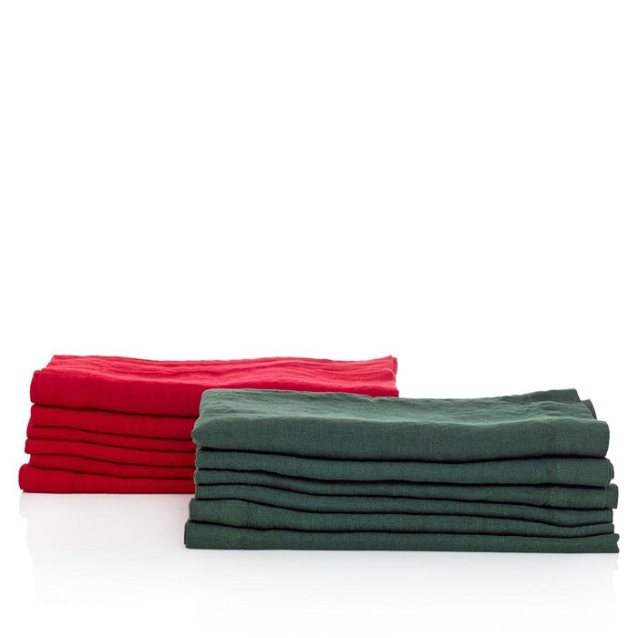Two stacks of hand-dyed linen napkins: Flame red and deep green, 22-inch square, with mitered corners.
