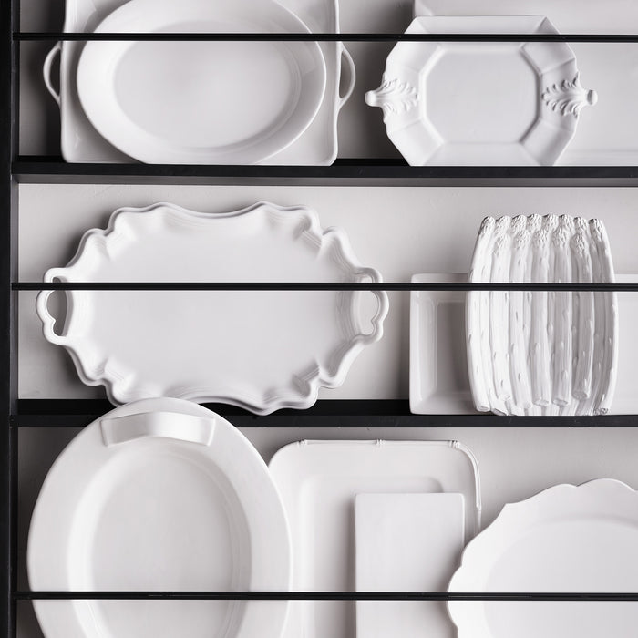 White ceramic Fleur de Lys octagon serving platter, 10.75"W x 15"L, with classic French detailing.