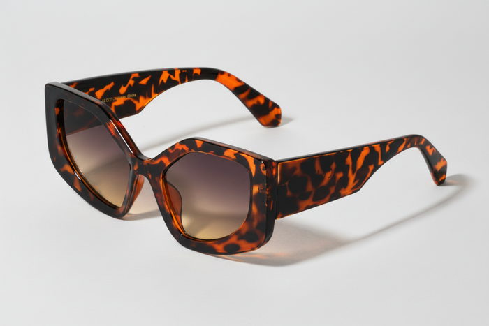 Sunglasses with tortoiseshell frame and brown lenses on a white background