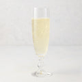 Georgia Eco-Crystal Champagne Glass, 8oz, filled with sparkling champagne, ribbed glass design.
