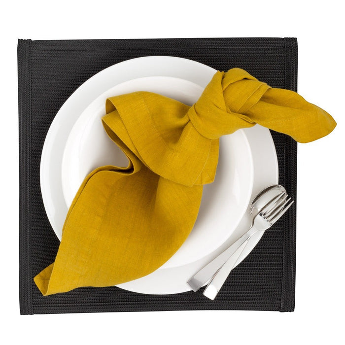 Gio Ponti Stainless Steel 5-piece flatware set with mirror finish, fork and spoon, on white plate with yellow napkin.