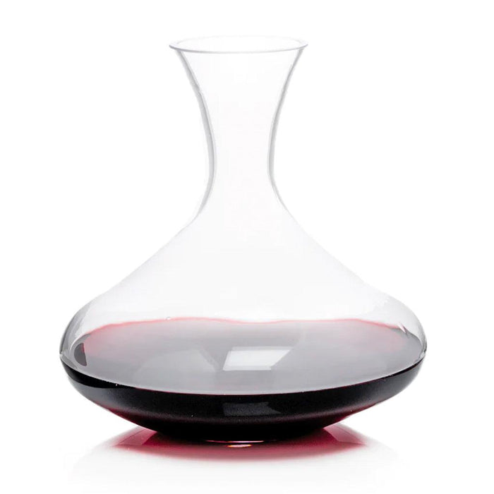 Clear mouth-blown glass wine carafe with a broad base and curved neck, partially filled with red wine.