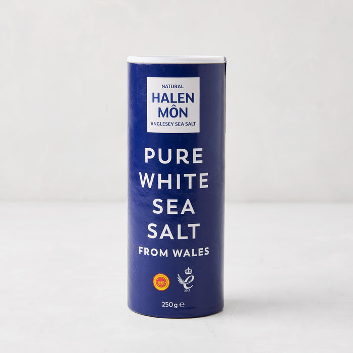 Halen Mon Pure White Sea Salt from Wales, 250g, in a tall blue and white cylindrical container.