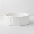 Handmade creamy white ceramic dog bowl by Montes Doggett, 8"Dia x 3"H, with textured sides.