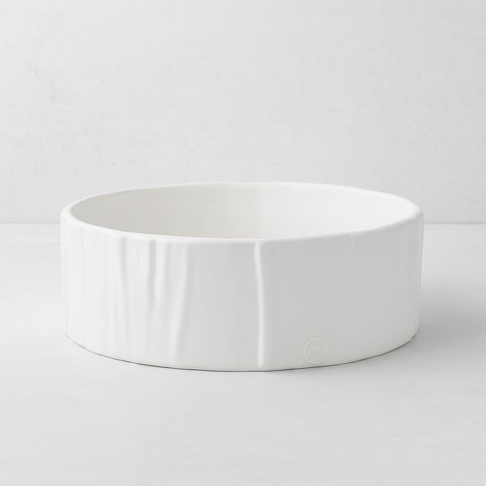 Handmade creamy white ceramic dog bowl by Montes Doggett, 8"Dia x 3"H, with textured sides.