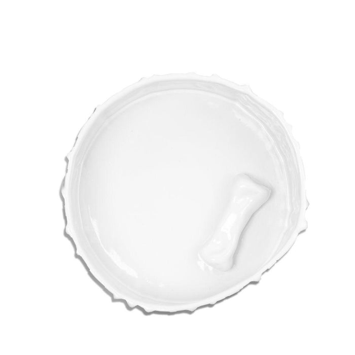Handmade creamy white ceramic dog bowl by Montes Doggett, 8"Dia, with a bone shape at the bottom.